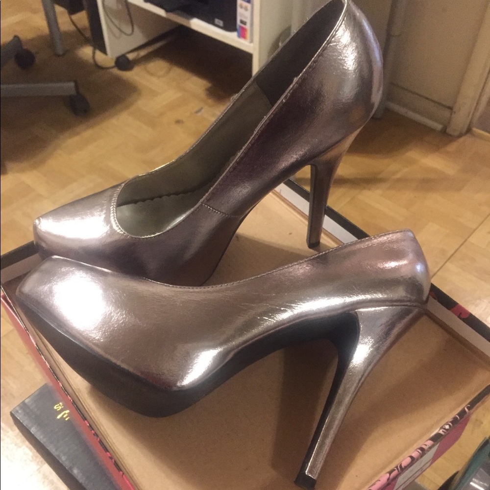 Silver pumps, shining new, in the box.